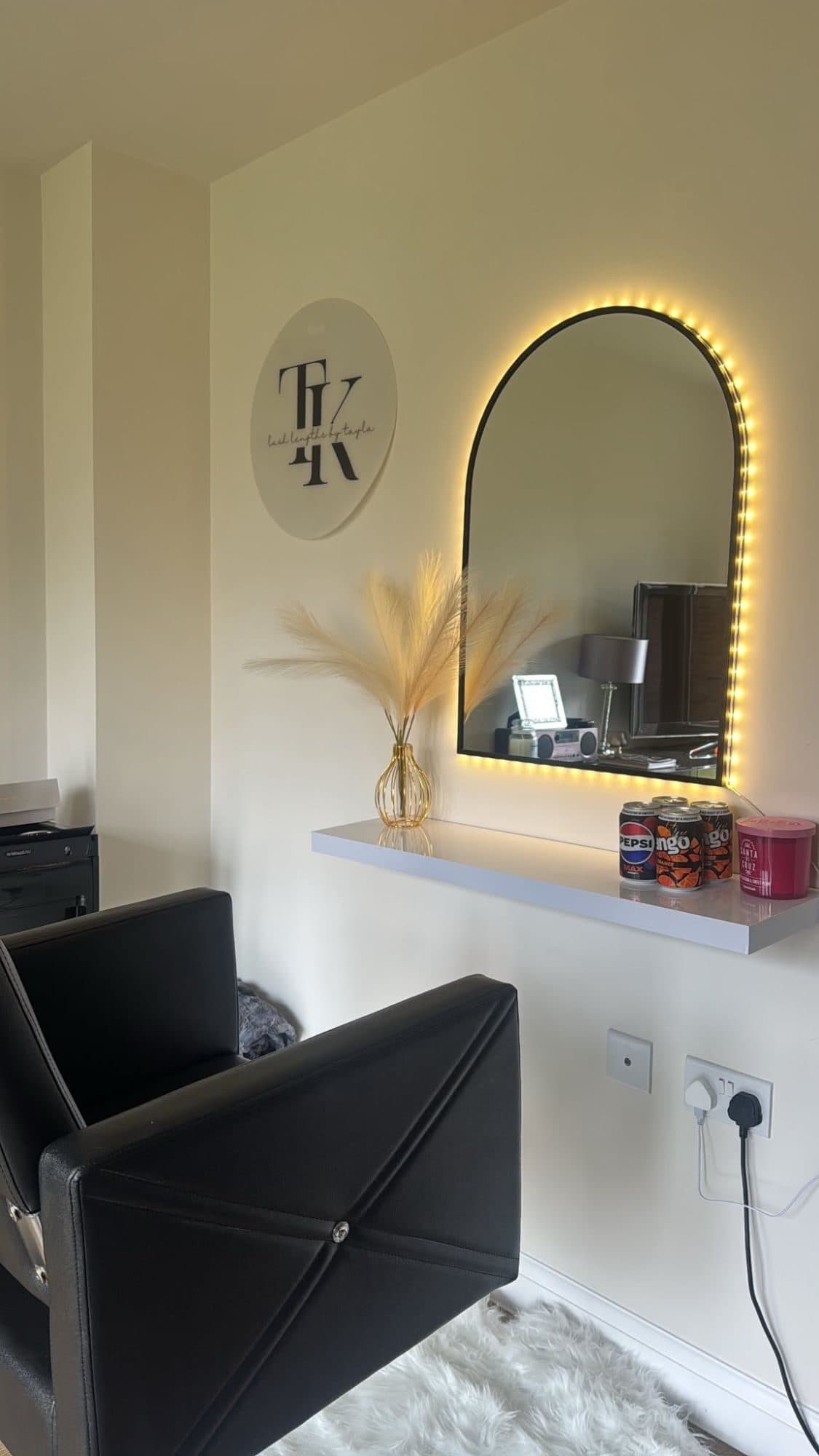 The styling chair, lit mirror and Lush Lengths by Tayla sign in the Peterborough home studio