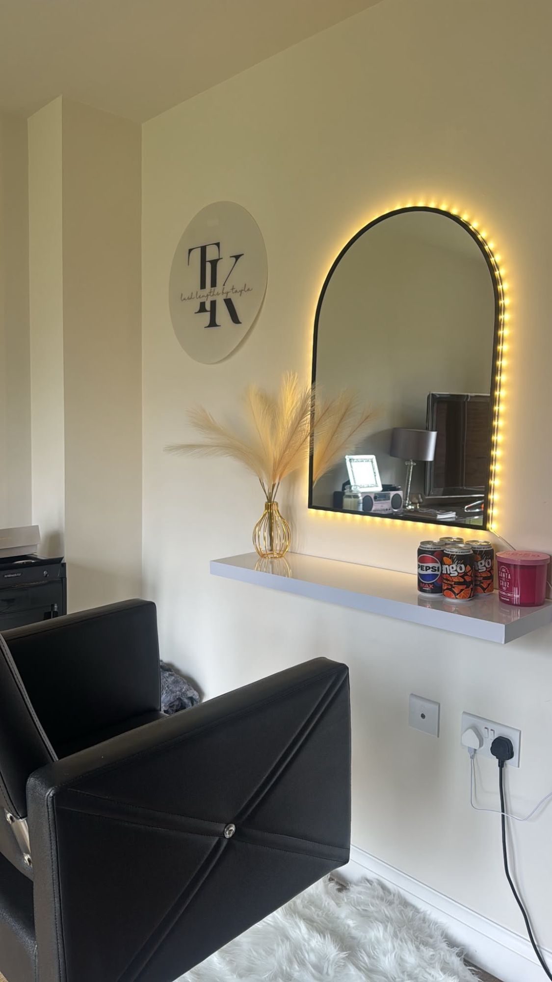 The styling chair, lit mirror and Lushlengthsbytayla sign in the Peterborough home studio