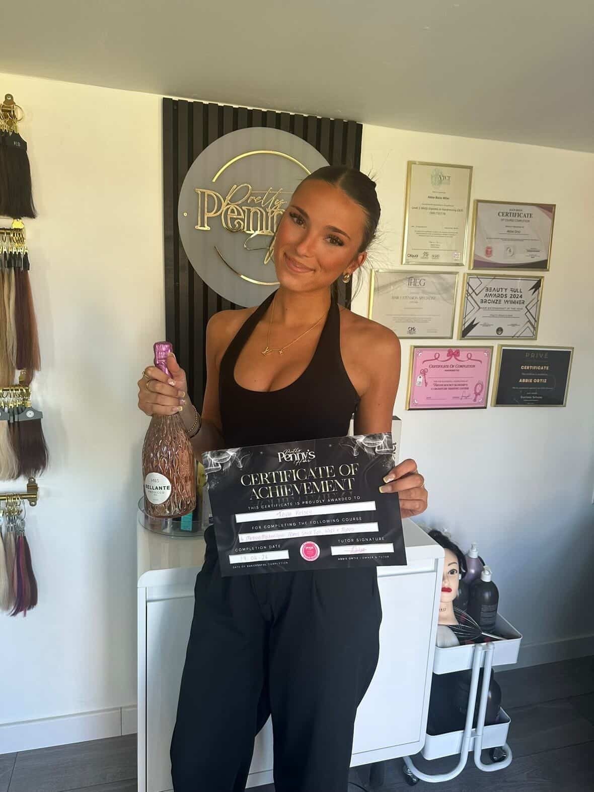 Tayla holding her hair extensions training certificate