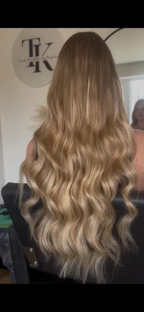 Tayla blow-drying a client's hair